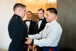 A Perfect USMC Wedding in Pensacola – Bobby & Kaisey’s Big Day 14 man getting ready in usmc dress blues before wedding