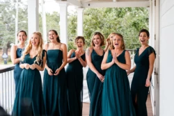 A Perfect USMC Wedding in Pensacola – Bobby & Kaisey’s Big Day 16 bridesmaids smiling and clapping in dark teal green dresses
