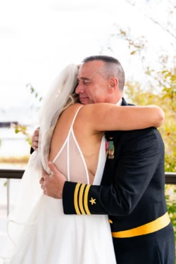 A Perfect USMC Wedding in Pensacola – Bobby & Kaisey’s Big Day 18 father in military dress blues hugging bride in wedding dress before wedding