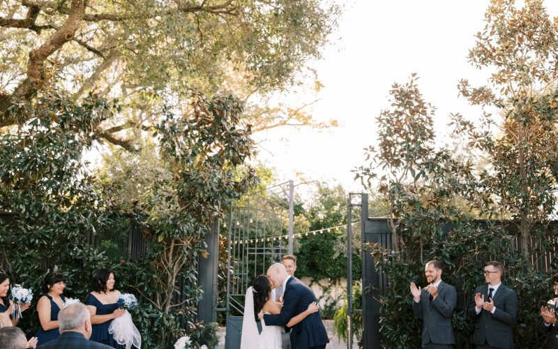 Bret and Ella at the end of the ceremony aisle under the oaks at Supposey Warehouse and Gardens